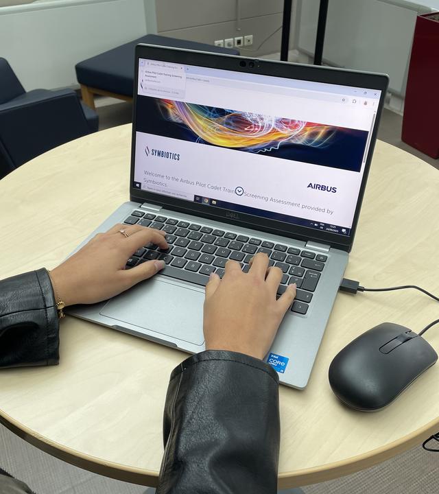 Symbiotics assessment hands on a compputer to star the Symbiotics onkline assessment