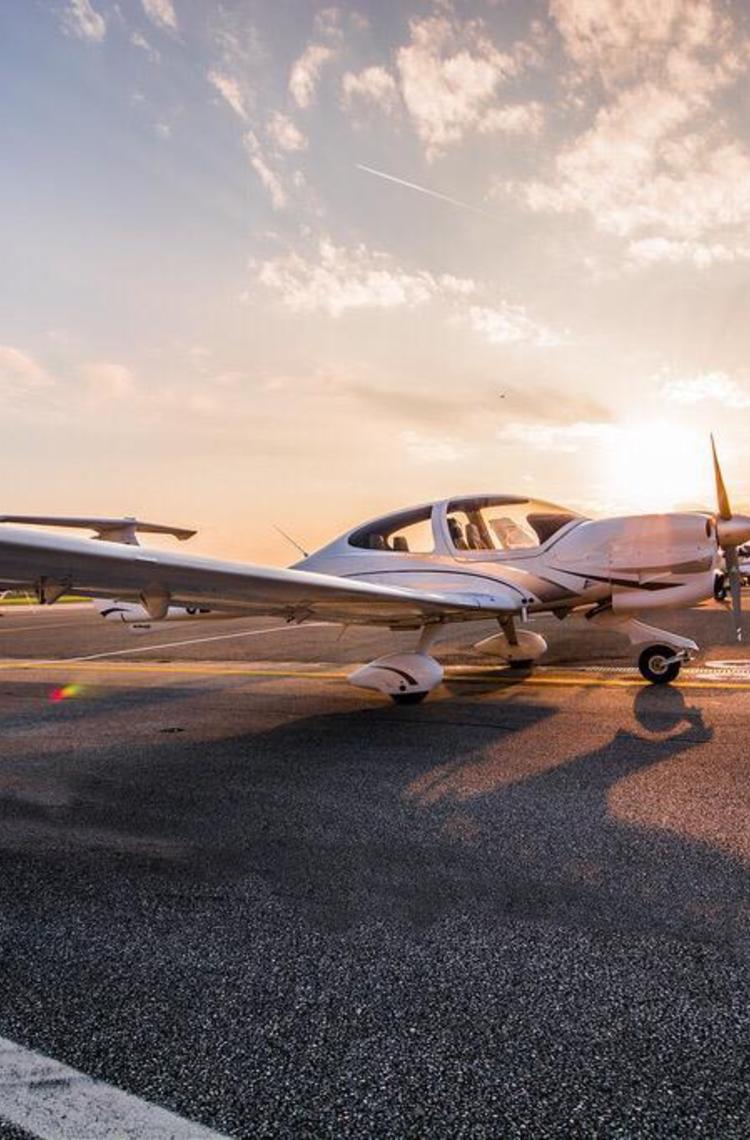 aircraft at SFA aircraft on a tarmac in front of a sunset